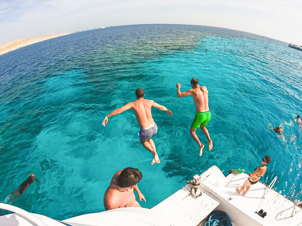 A wonderful shot of two people jumping into the water on one of the beaches of Ras Mohammed