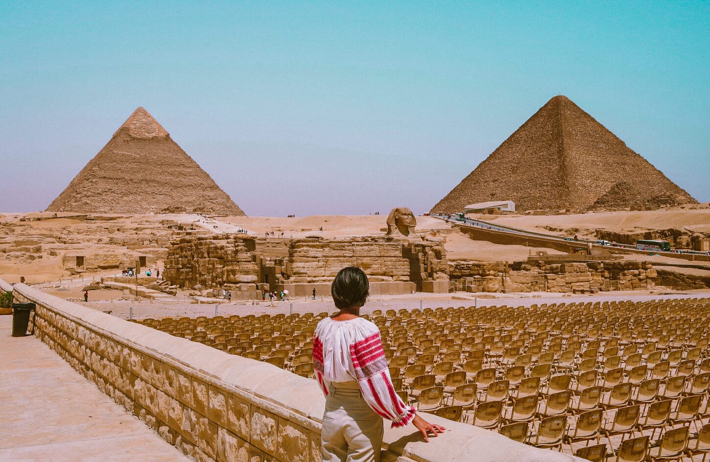 A girl watching the pyramids and the Sphinx