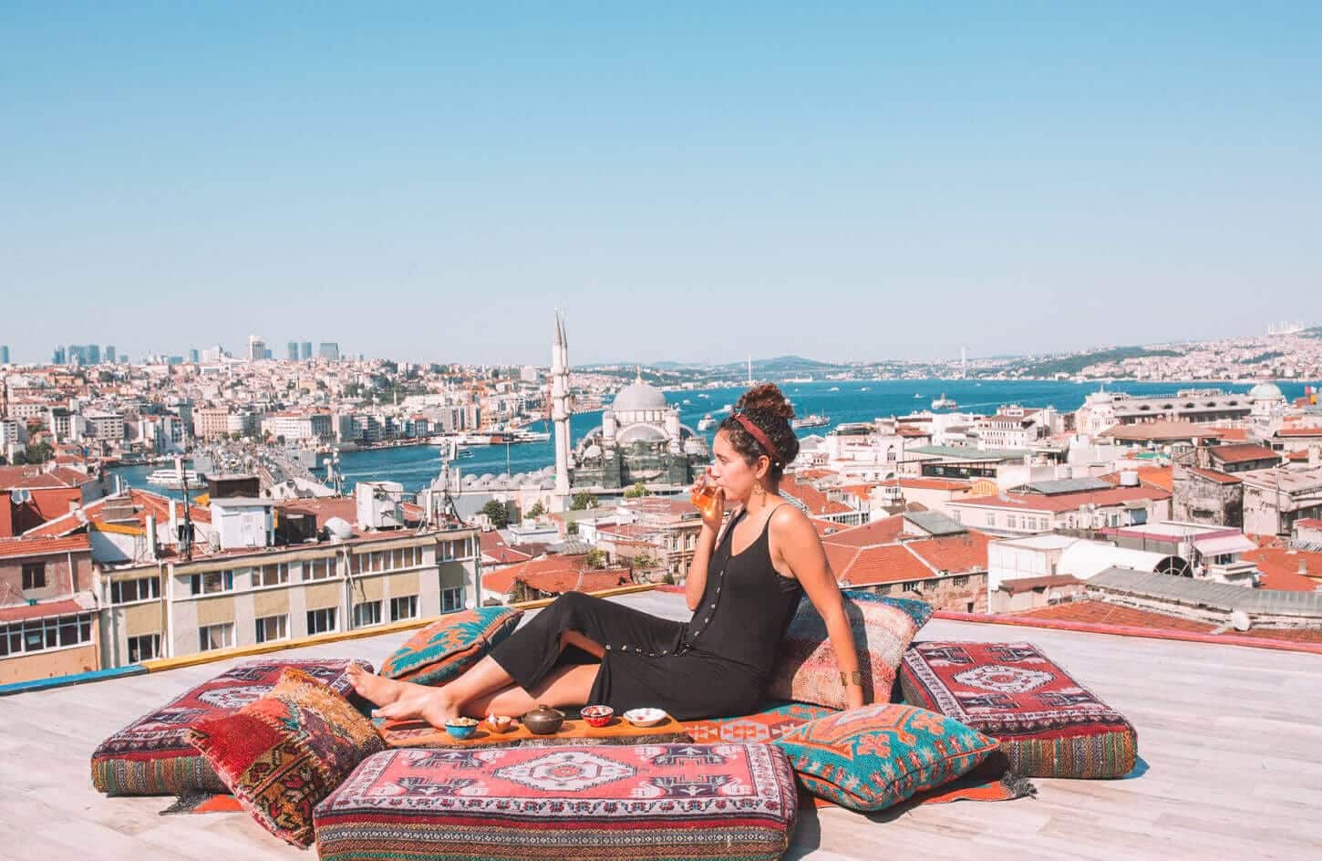 A picture of a tourist relaxing in one of the hotels overlooking the Blue Mosque in Turkiye