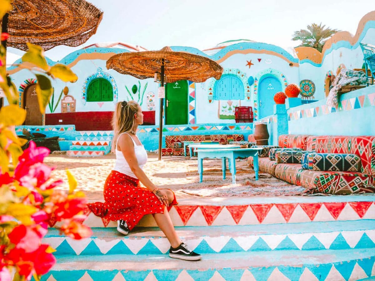 A tourist enjoys sitting in the Nubian village