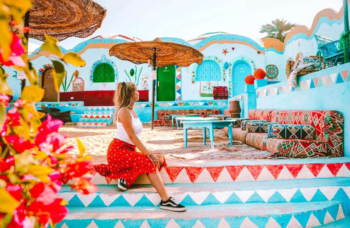 A tourist enjoys sitting in the Nubian village