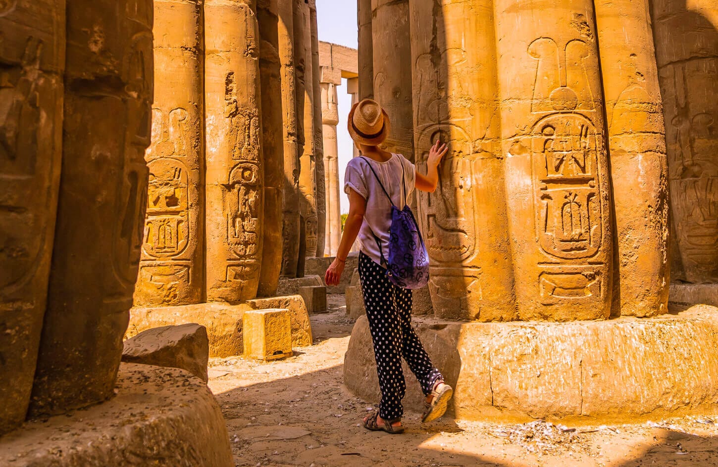 A tourist near one of the columns of Karnak Temple