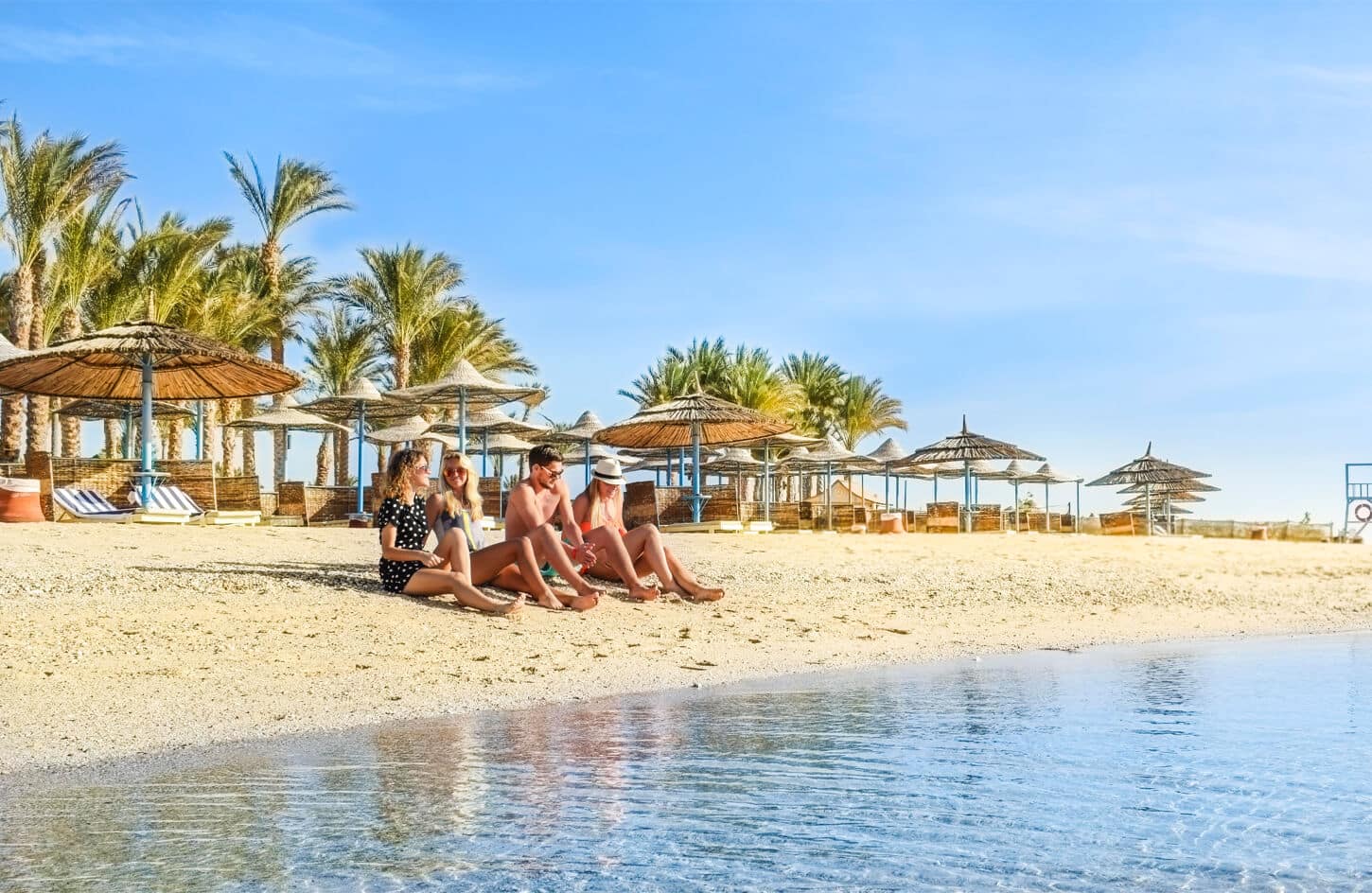 A very beautiful picture of a group of tourists on the beach in Port Ghalib