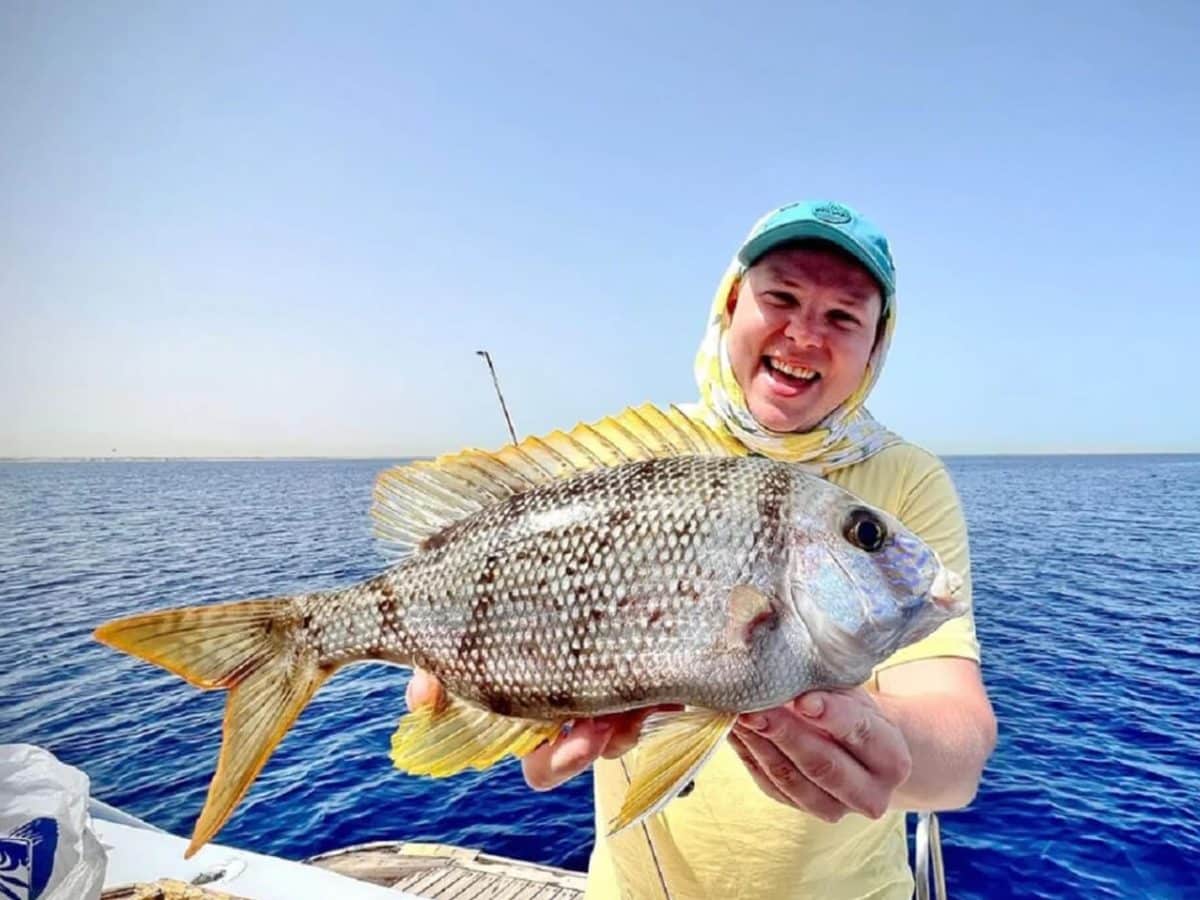 A very nice picture of a child tourist on a fishing trip in Hurghada