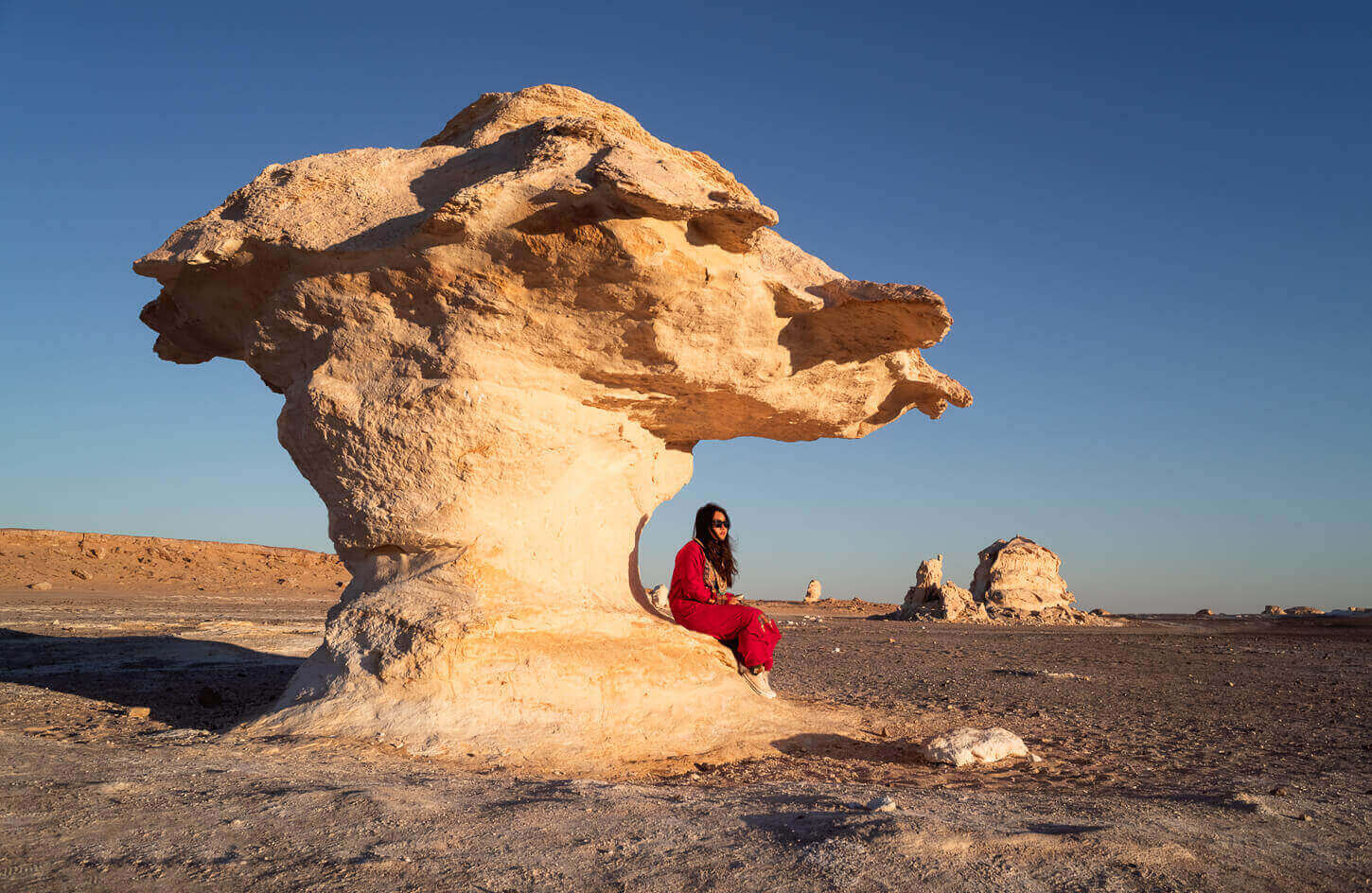 A wonderful picture of a girl on one of the white dunes of the White Desert