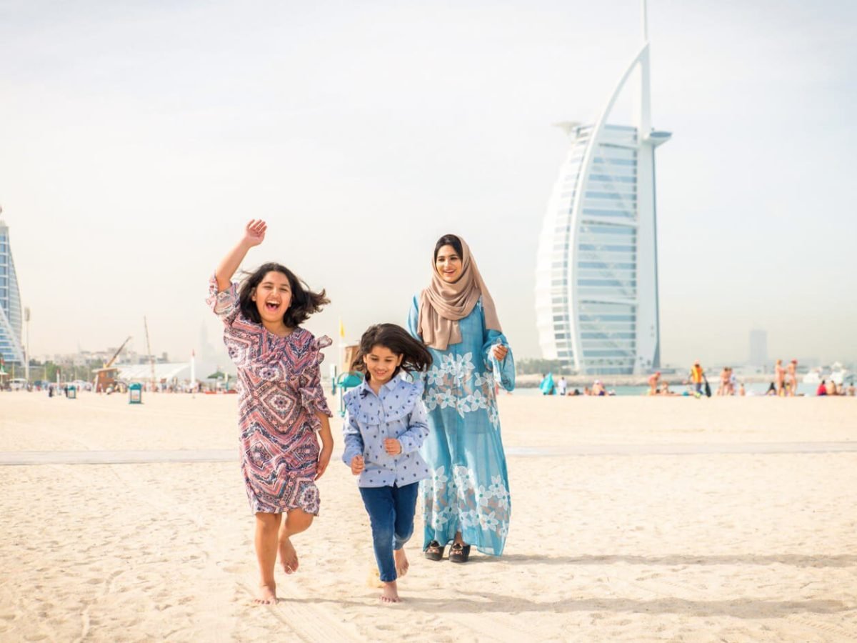 A wonderful picture of a mother and her two children in front of Burj Al Arab