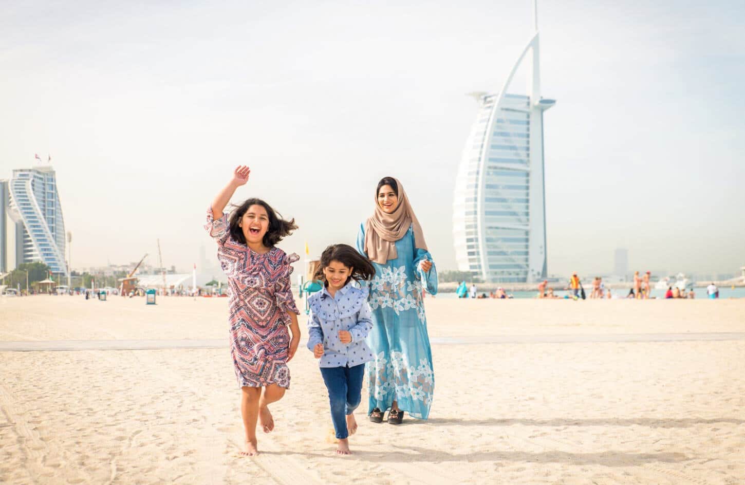 A wonderful picture of a mother and her two children in front of Burj Al Arab