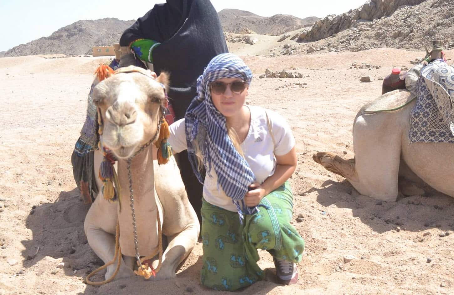 A wonderful picture of a woman in the Marsa Alam desert with camels