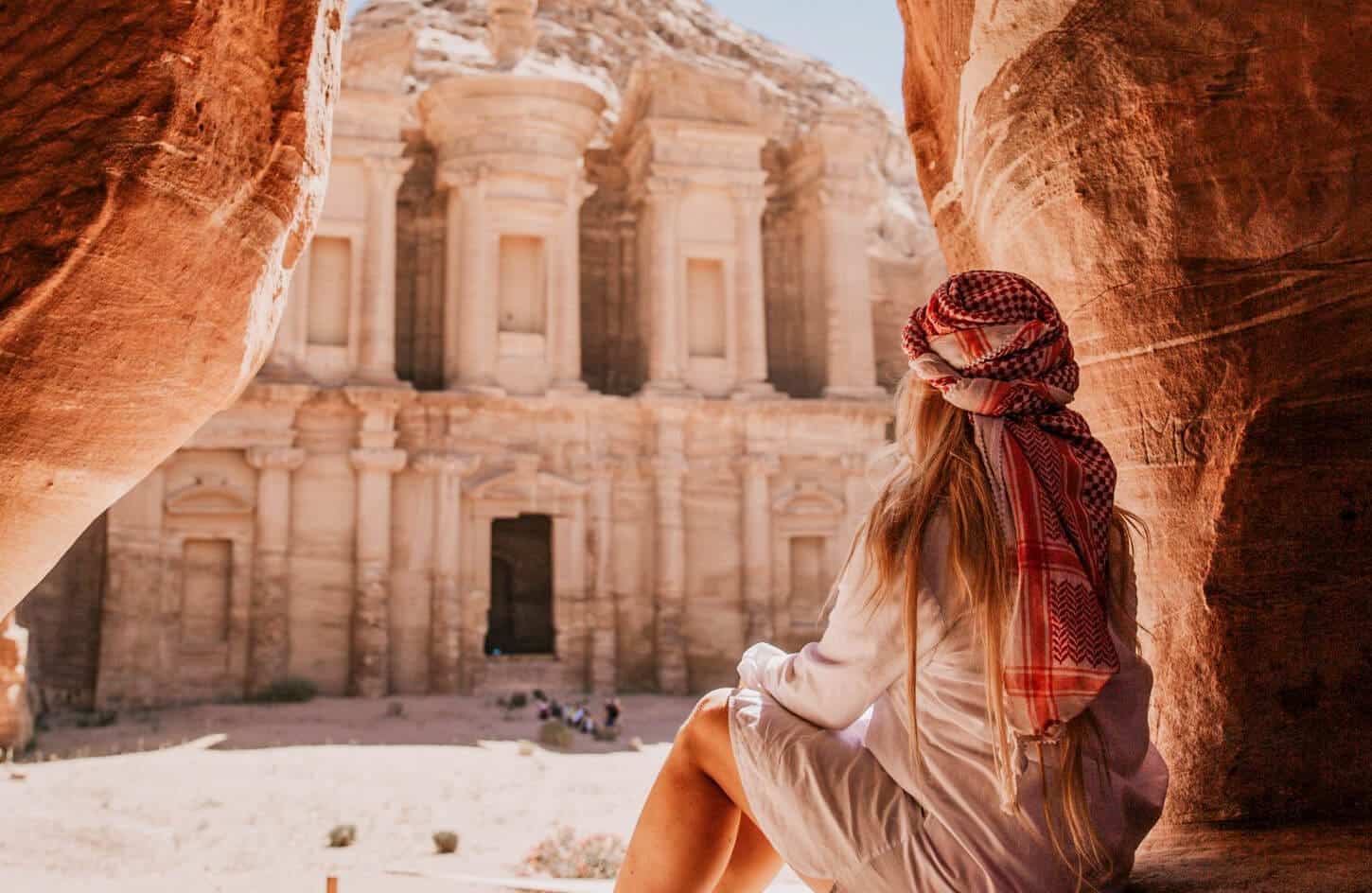 A wonderful shot of a girl from one of the caves in front of the Petra Temple in Jordan