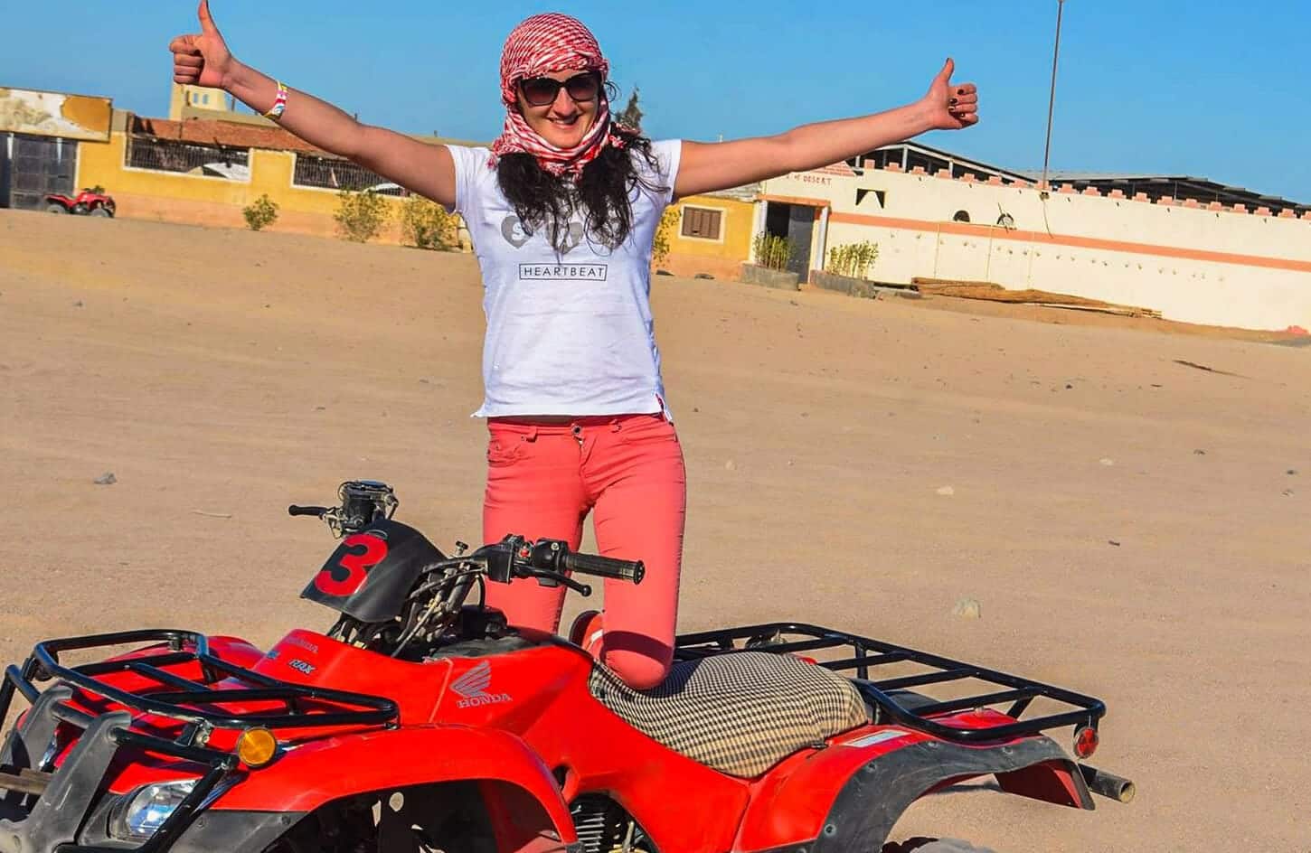 A wonderful shot of a girl getting ready to ride a quad bike