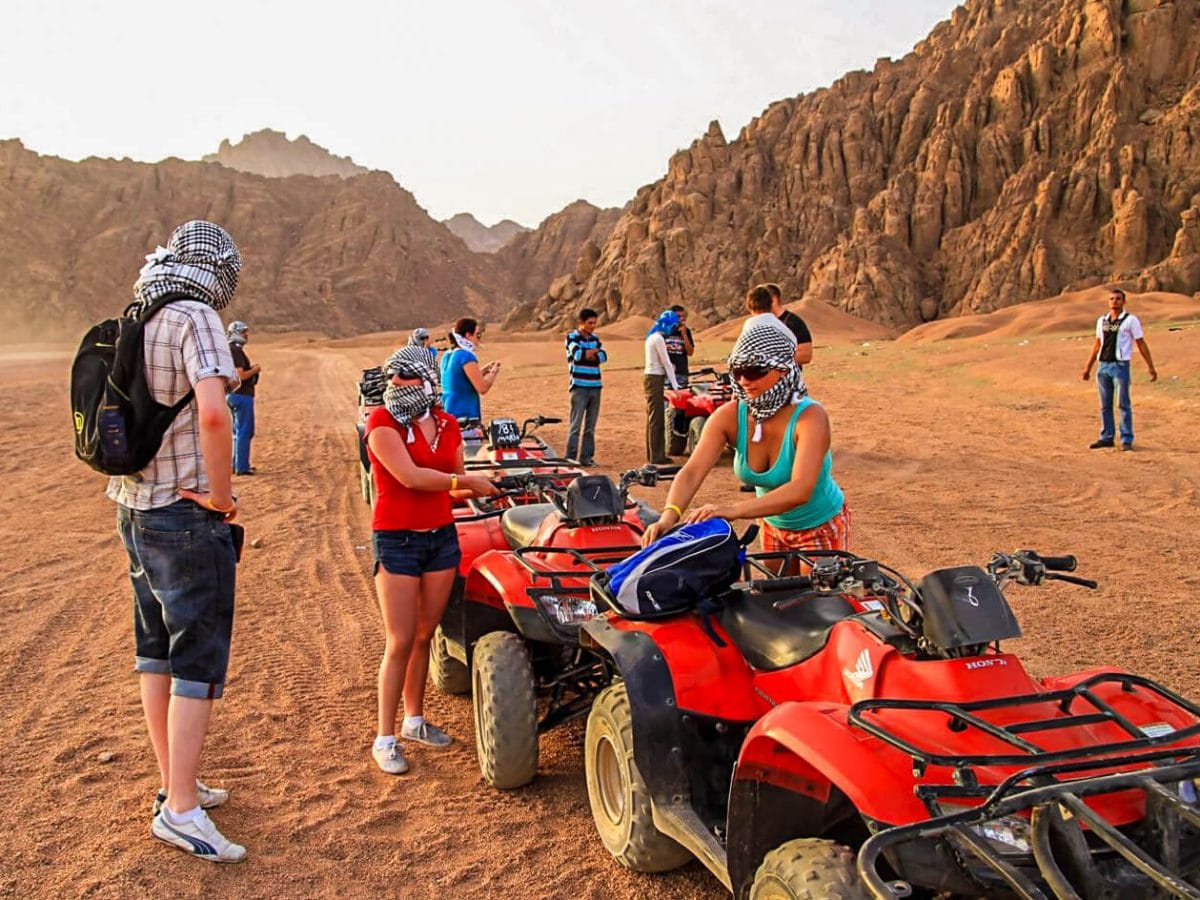 A wonderful shot of a group of people preparing to ride a quad bike from one of the safari trips in Hurghada
