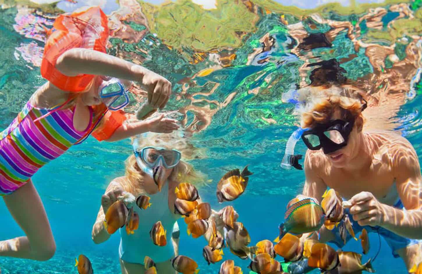 Great picture of a tourist and his children on a snorkeling trip to Sharm El Naga