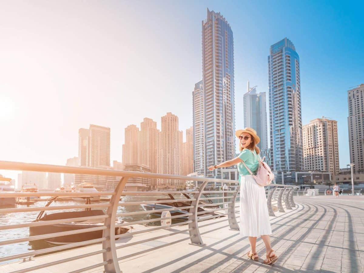 Very beautiful picture of a woman in front of Dubai Marina