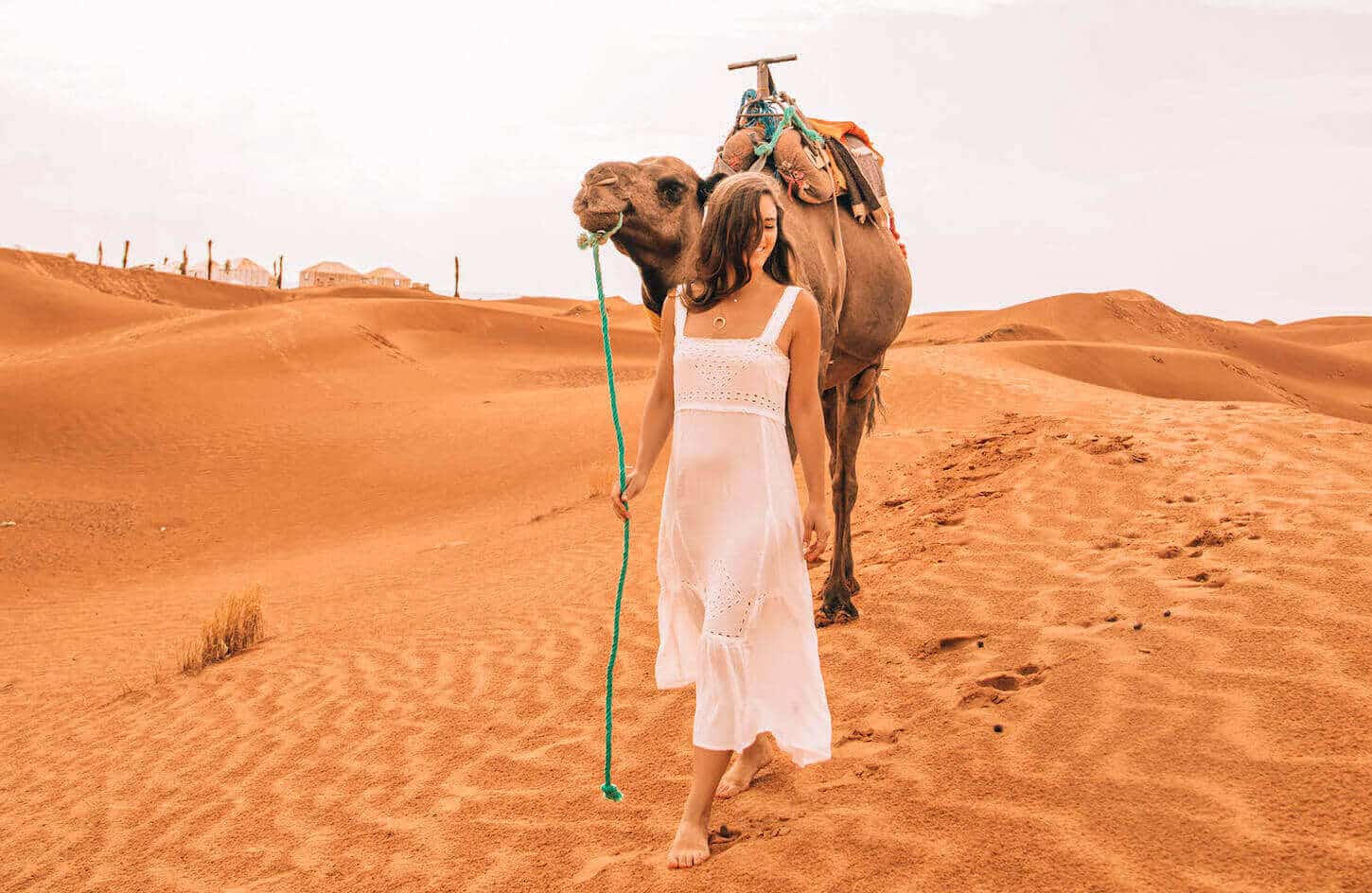 Wonderful pictures of a girl holding a camel in the Moroccan desert