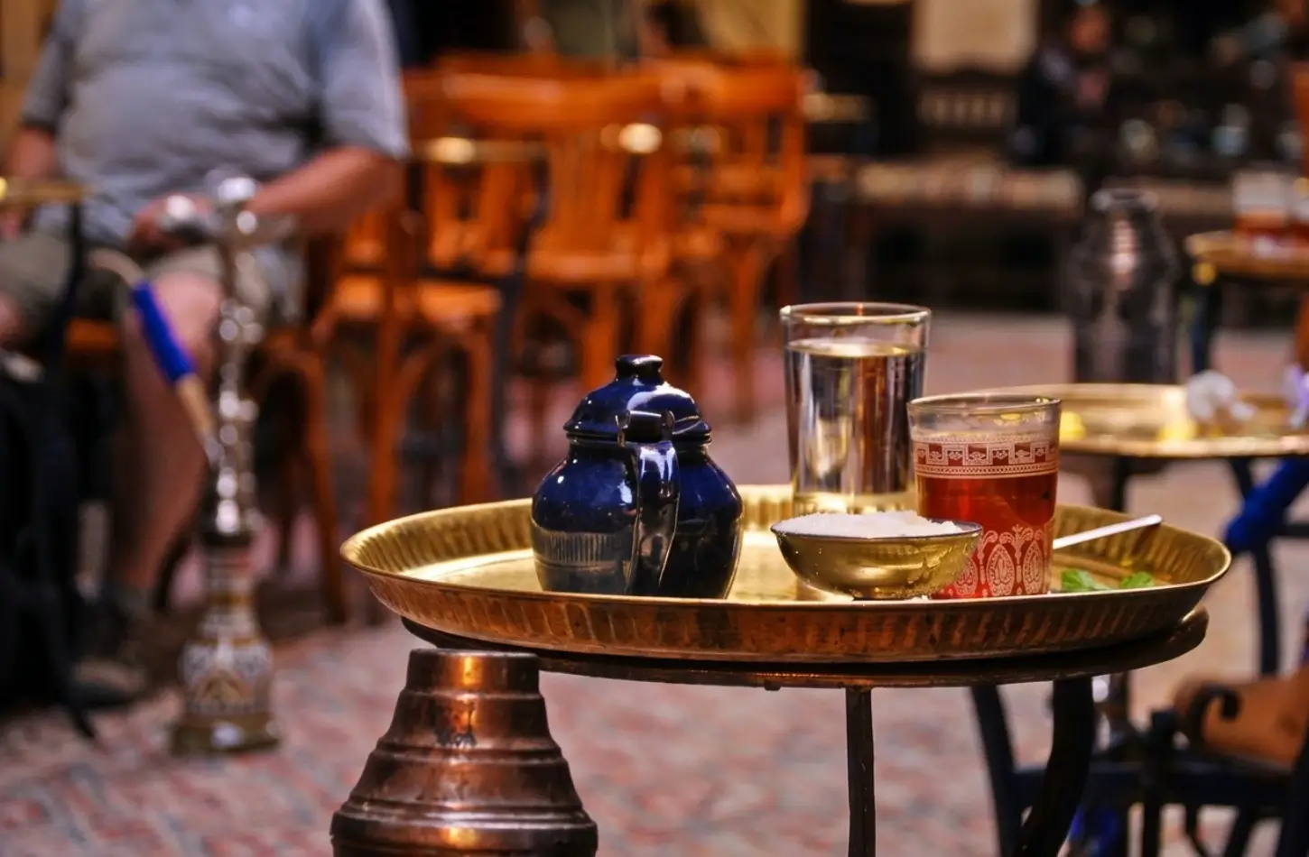 Cultural Etiquette in Egypt: The Complete Guide for Respectful Travelers 2 Traditional Egyptian tea and water served on a brass tray at a local cafe, representing social customs and cultural etiquette in Egypt.
