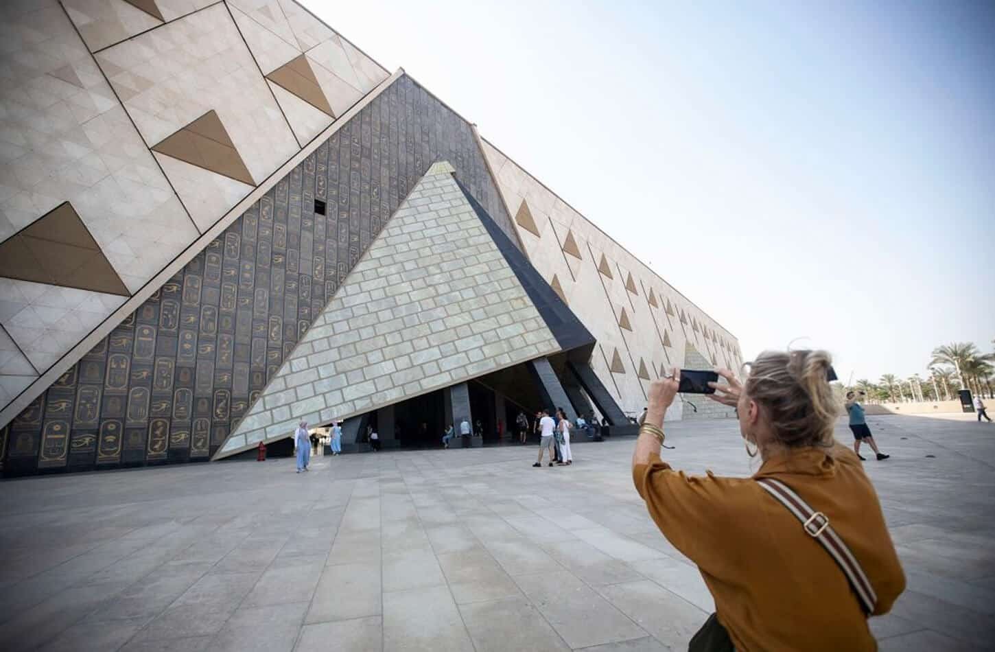 A wonderful picture of a woman in front of the Grand Egyptian Museum