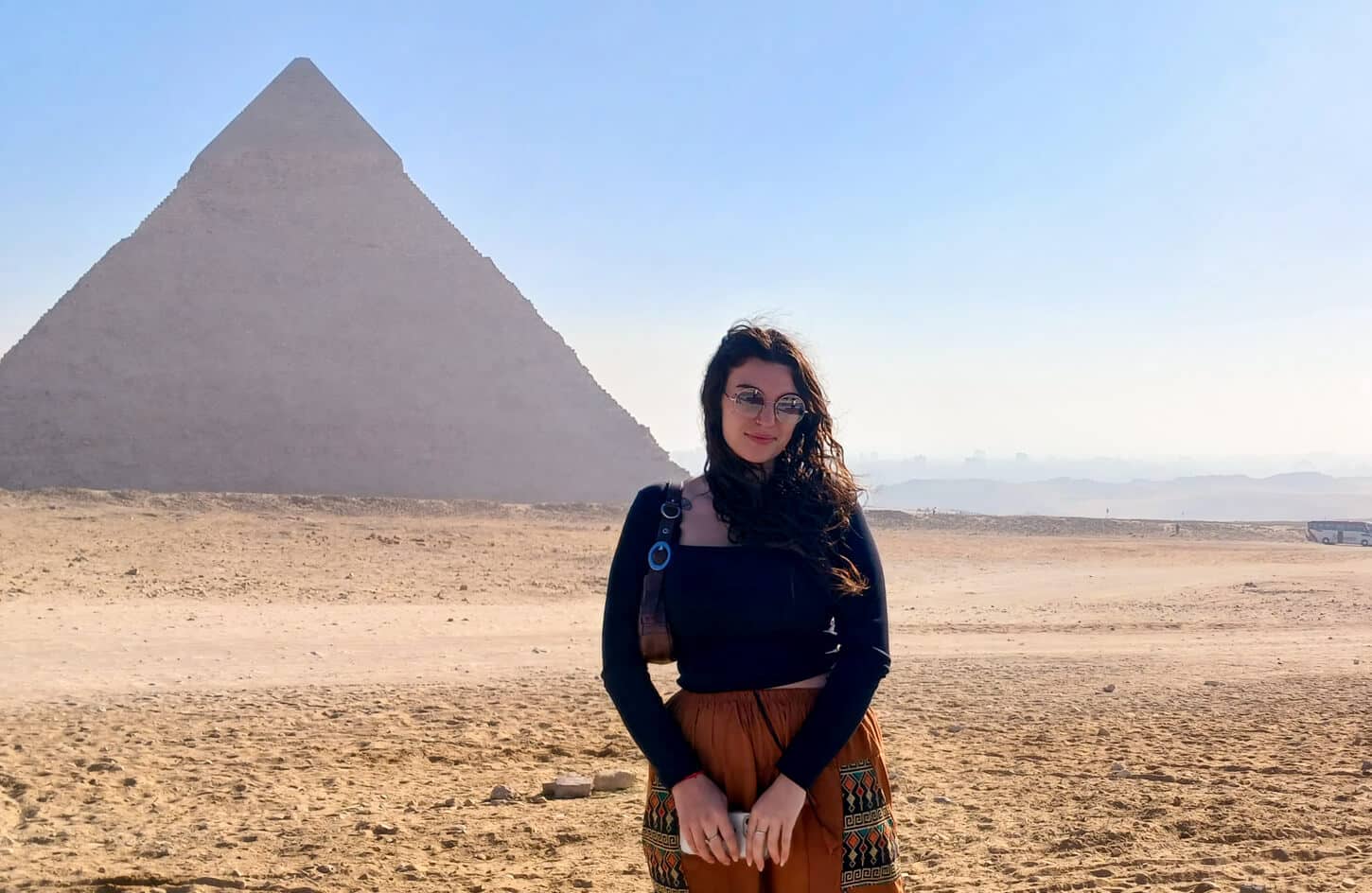 amazing shot of a girl in front of the great pyramid