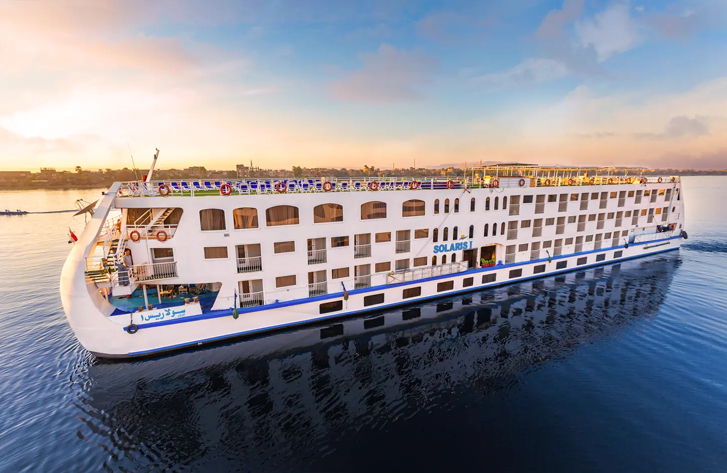 Best Places to Visit in Egypt: The Complete Travel Guide 3 Luxury Nile cruise ship sailing between Luxor and Aswan, Egypt, at sunset