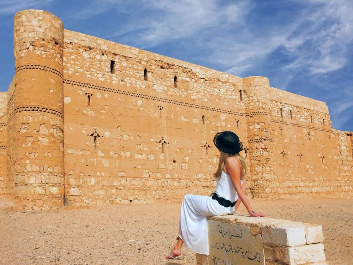 a special shot of a tourist in front of qasr al kharraneh