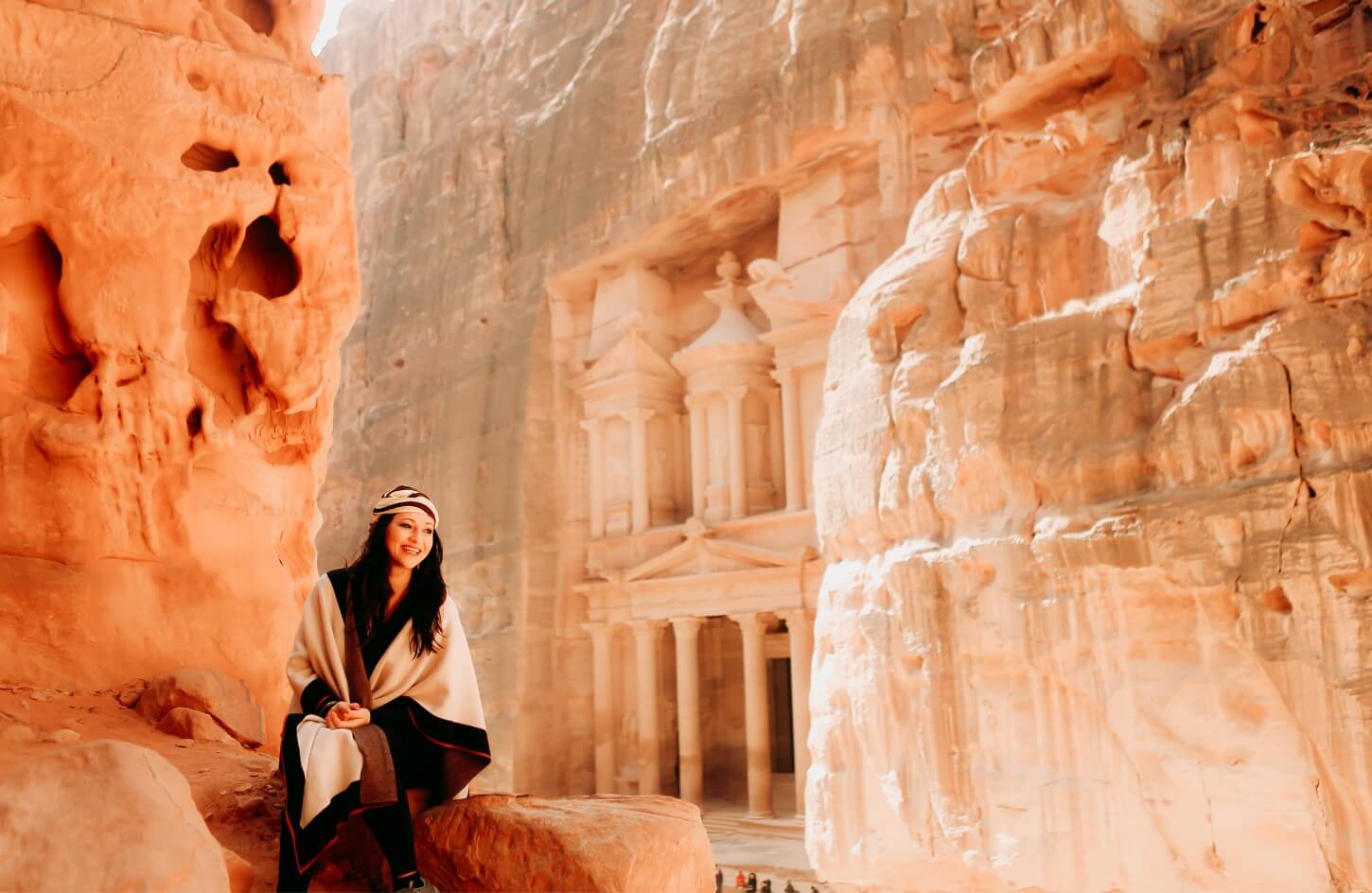 a wonderful shot of a girl in front of the great petra temple in jordan