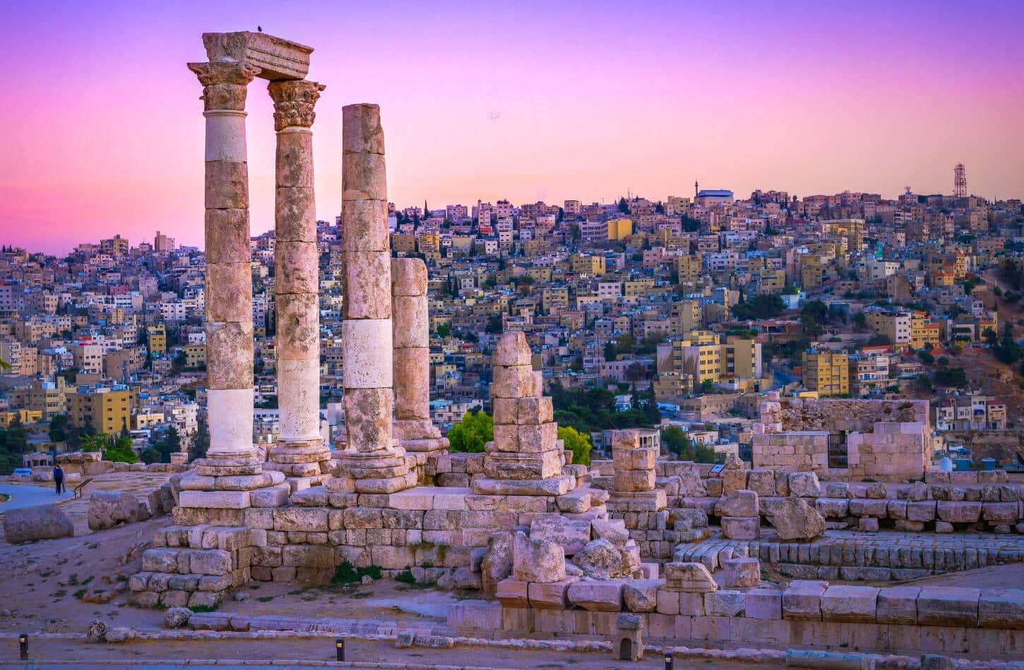 ancient roman columns of the amman citadel overlooking the city at sunset