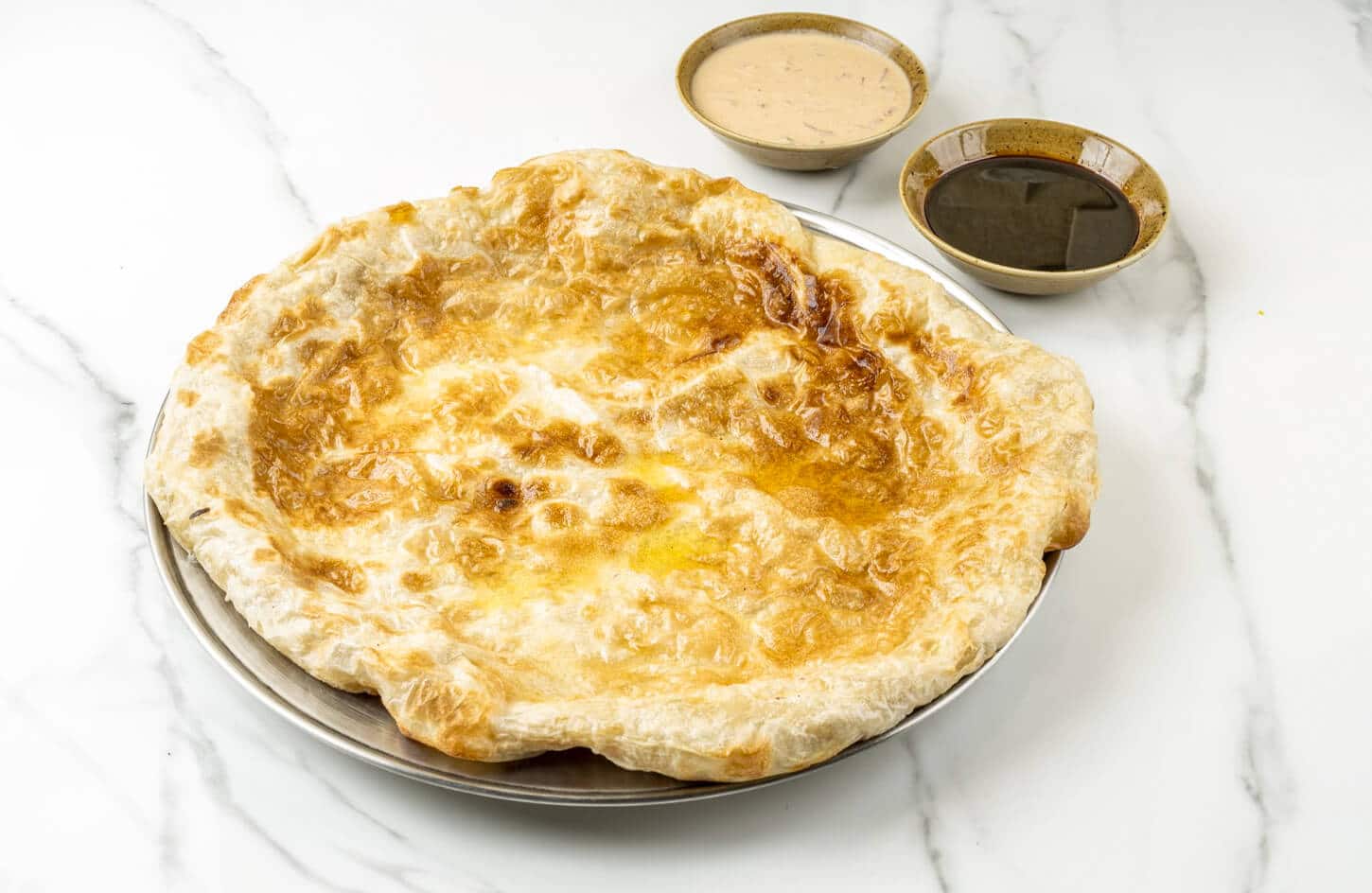 Egyptian feteer meshaltet flaky layered pastry with butter folds, sweet and savory versions