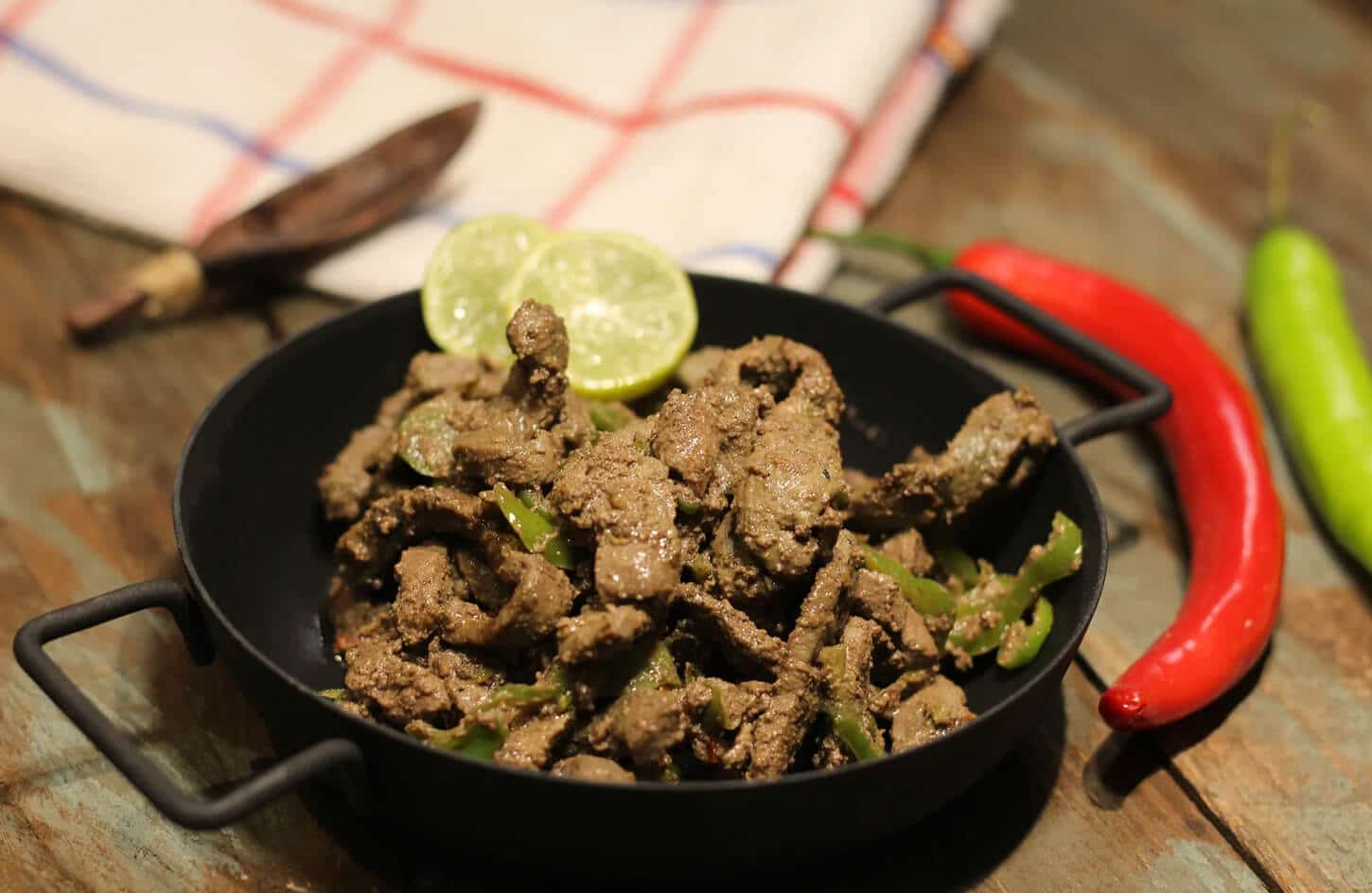 Egyptian alexandrian kebda liver sandwich with garlic and green chili in an eish fino bread roll