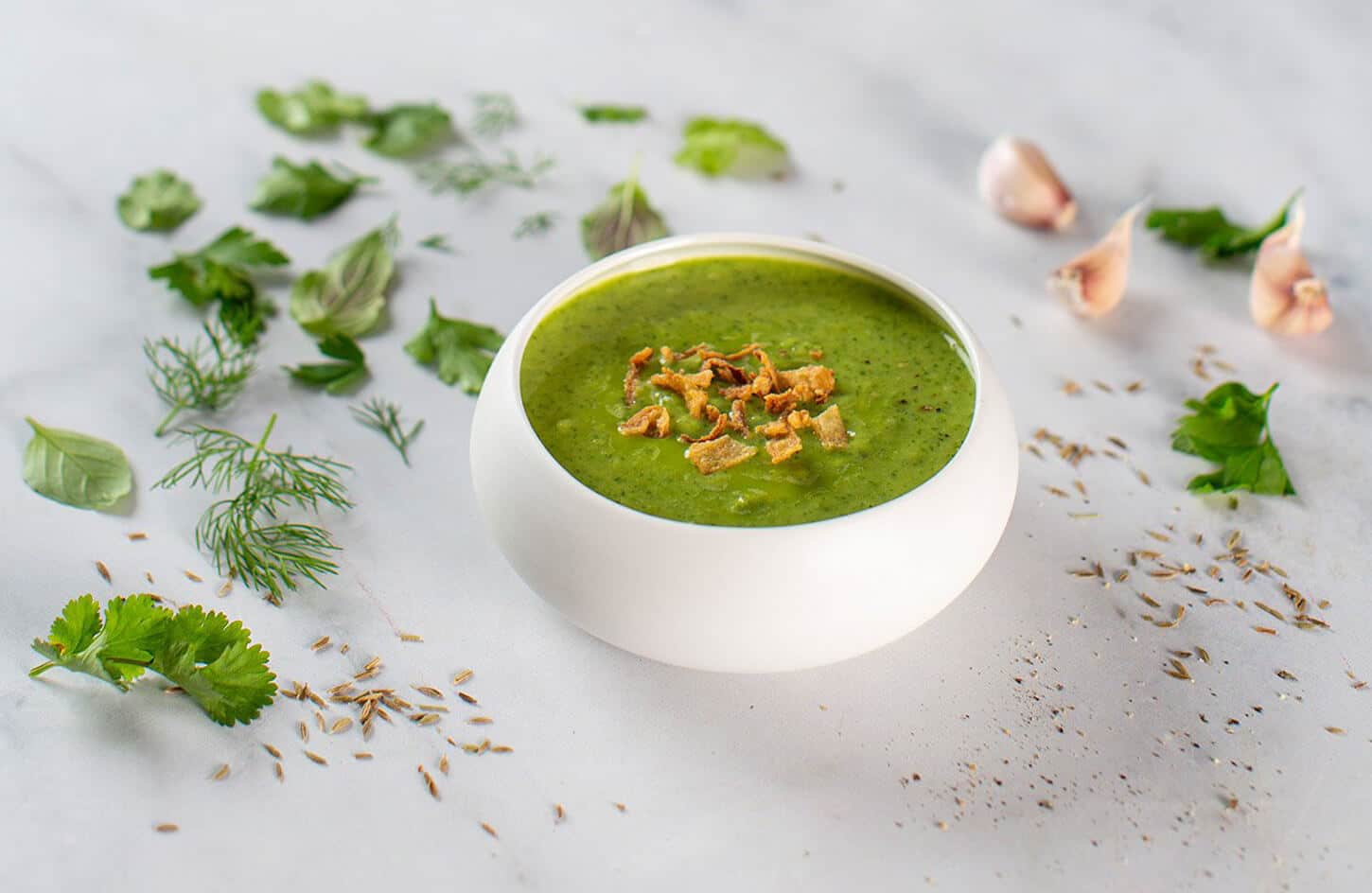 Egyptian besarah green fava bean and herb dip with fried onions in a traditional bowl