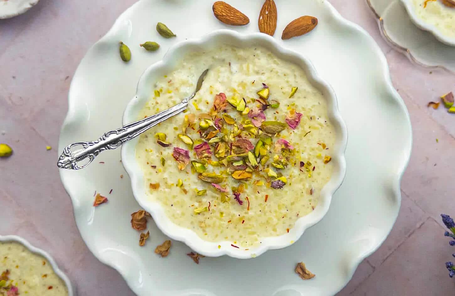 Egyptian roz bi laban cold rice pudding with rose water, cinnamon, and pistachio topping