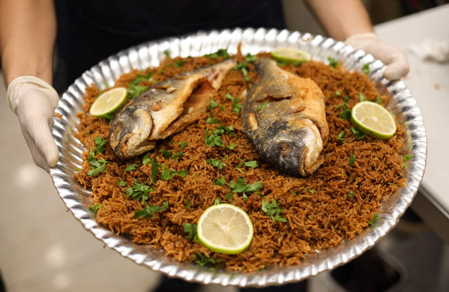Egyptian sayadiyah fish with caramelized onion rice and grilled sea bass, Alexandria seafood dish
