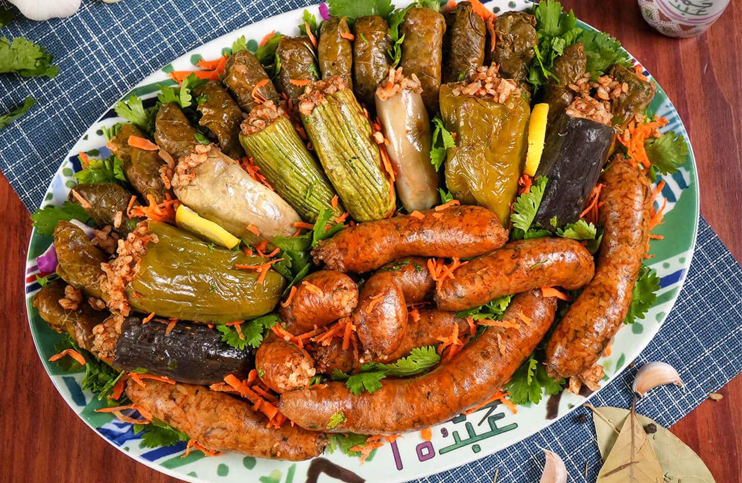 Egyptian mahshi plate of vegetables stuffed with rice and herbs, including zucchini and grape leaves