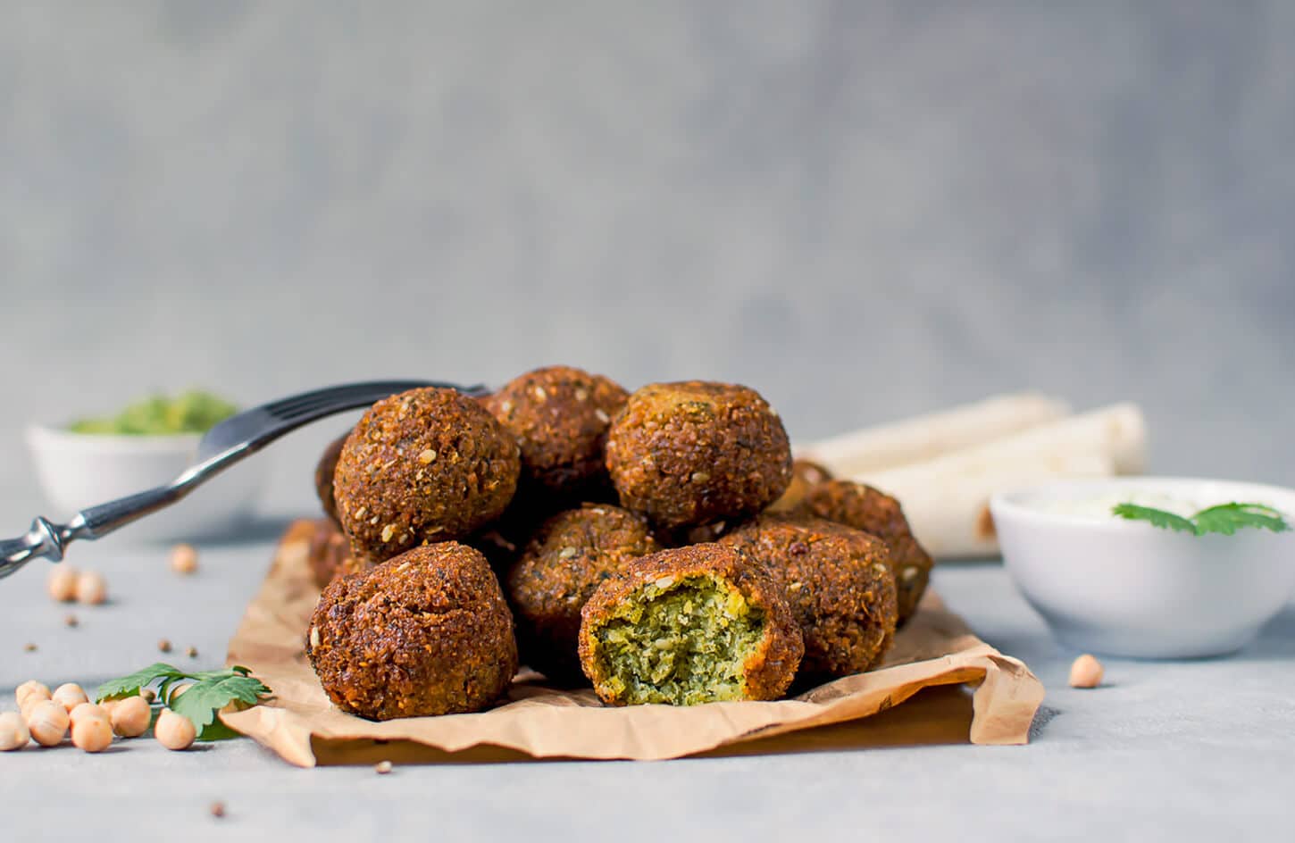 Egyptian ta'meya falafel patties made from fava beans, green inside, in a street food sandwich