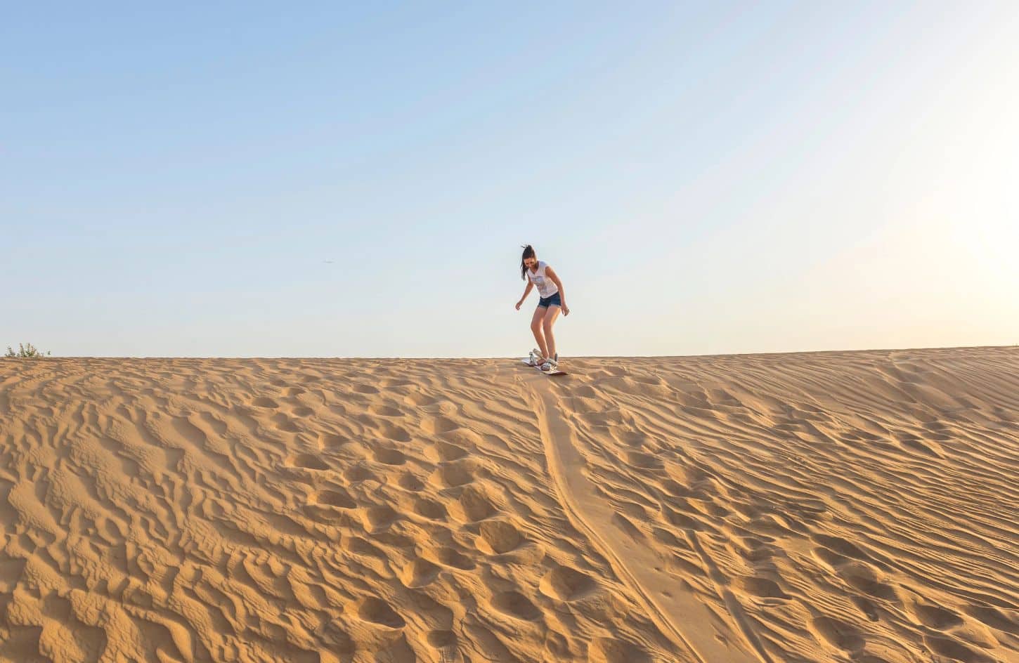 great shot of a girl sandboarding