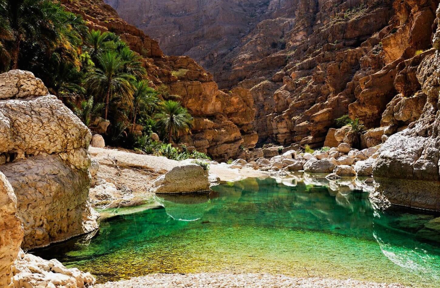 Natural rock pool oasis in a narrow Wadi gorge, a hidden gem of Oman nature - Best Time to Visit Oman