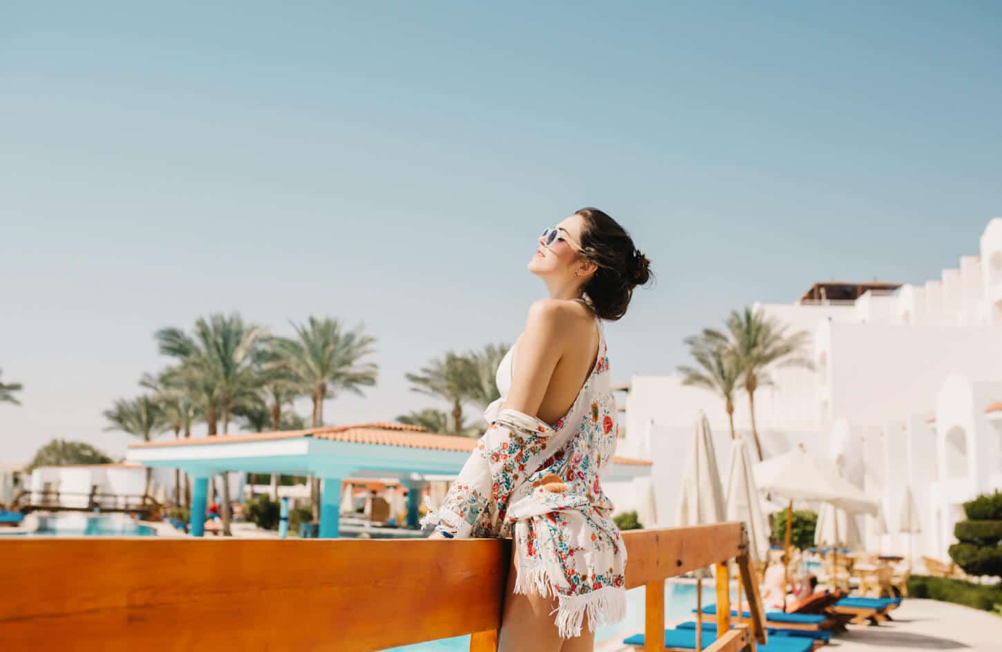 Female tourist enjoying the sun at a Sharm El Sheikh resort pool in Egypt.