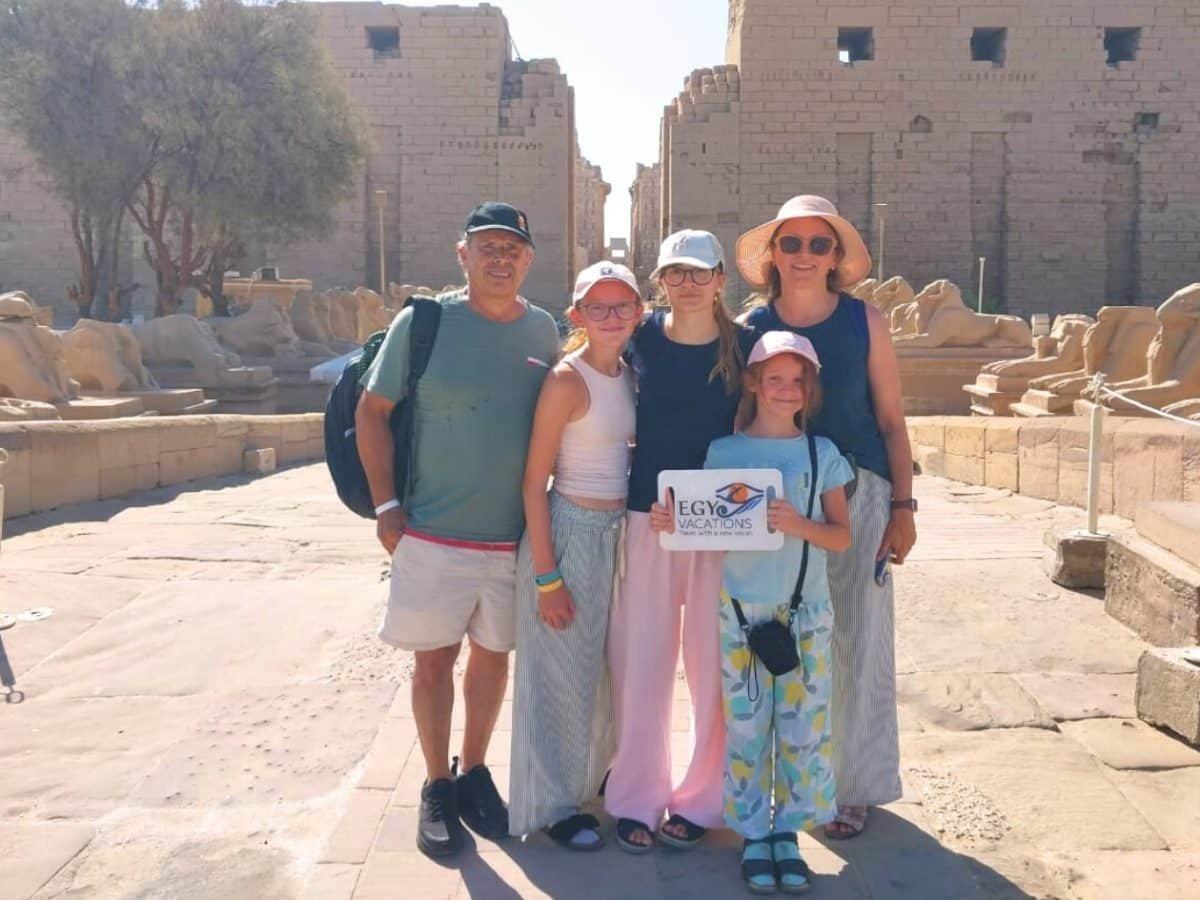 A family photographed in front of Luxor Temple