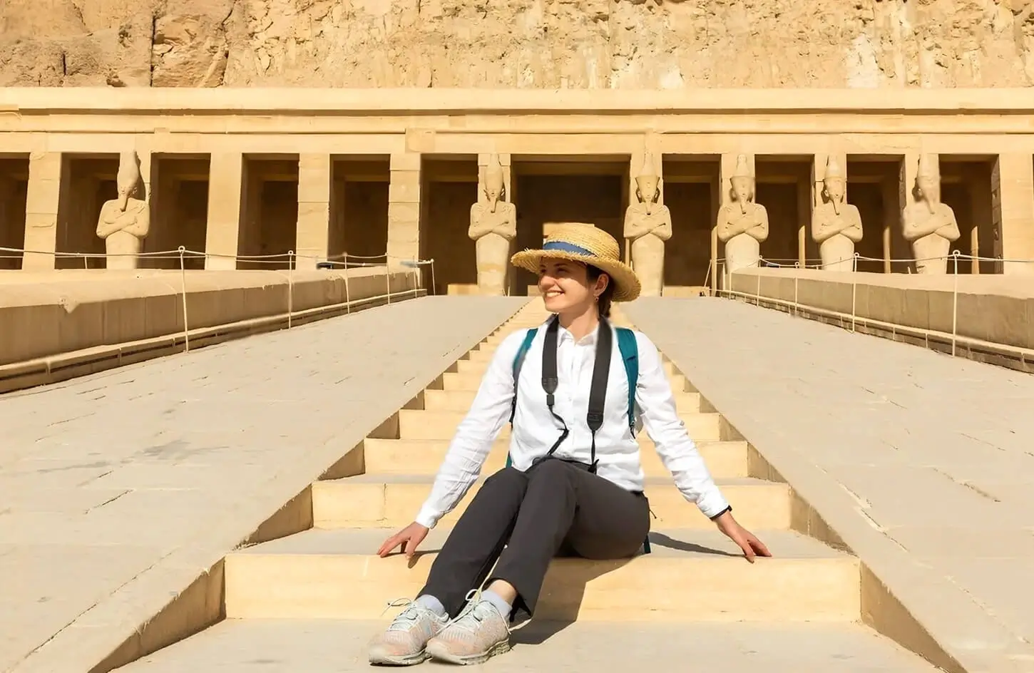Solo Female Travel in Egypt: Best Tour Packages & Safety Tips 2 A stunning image of a girl sitting on the steps of Hatshepsuts temple