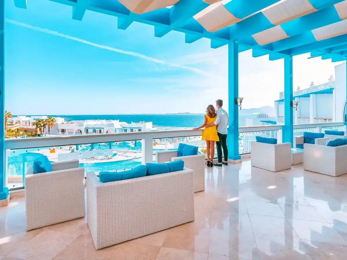 Couple enjoying the view from a luxury Red Sea hotel balcony with blue architecture and ocean views. - Summer in Egypt 