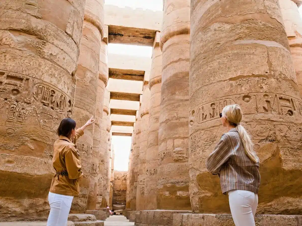Expert tour guide in Egypt pointing out hieroglyphics at the Karnak Temple complex in Luxor. - Do You Need a Tour Guide in Egypt? Here's the Honest Answer