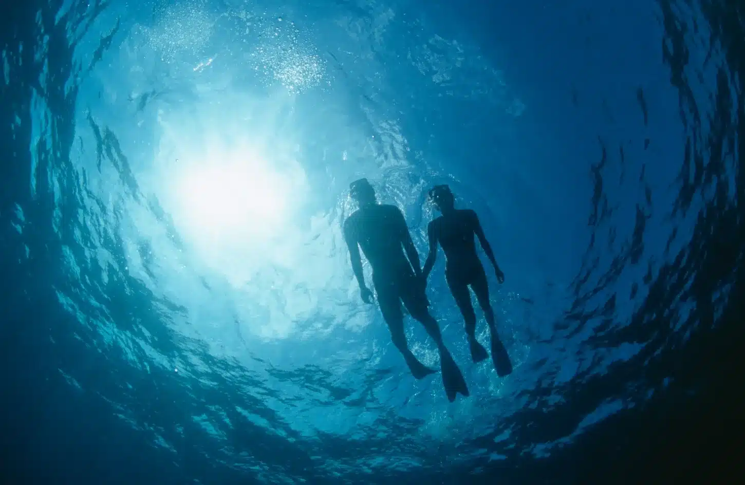 A stunning photo of a couple on one of their diving trips in the Egyptian seas. - Romantic Spots to Visit in Egypt