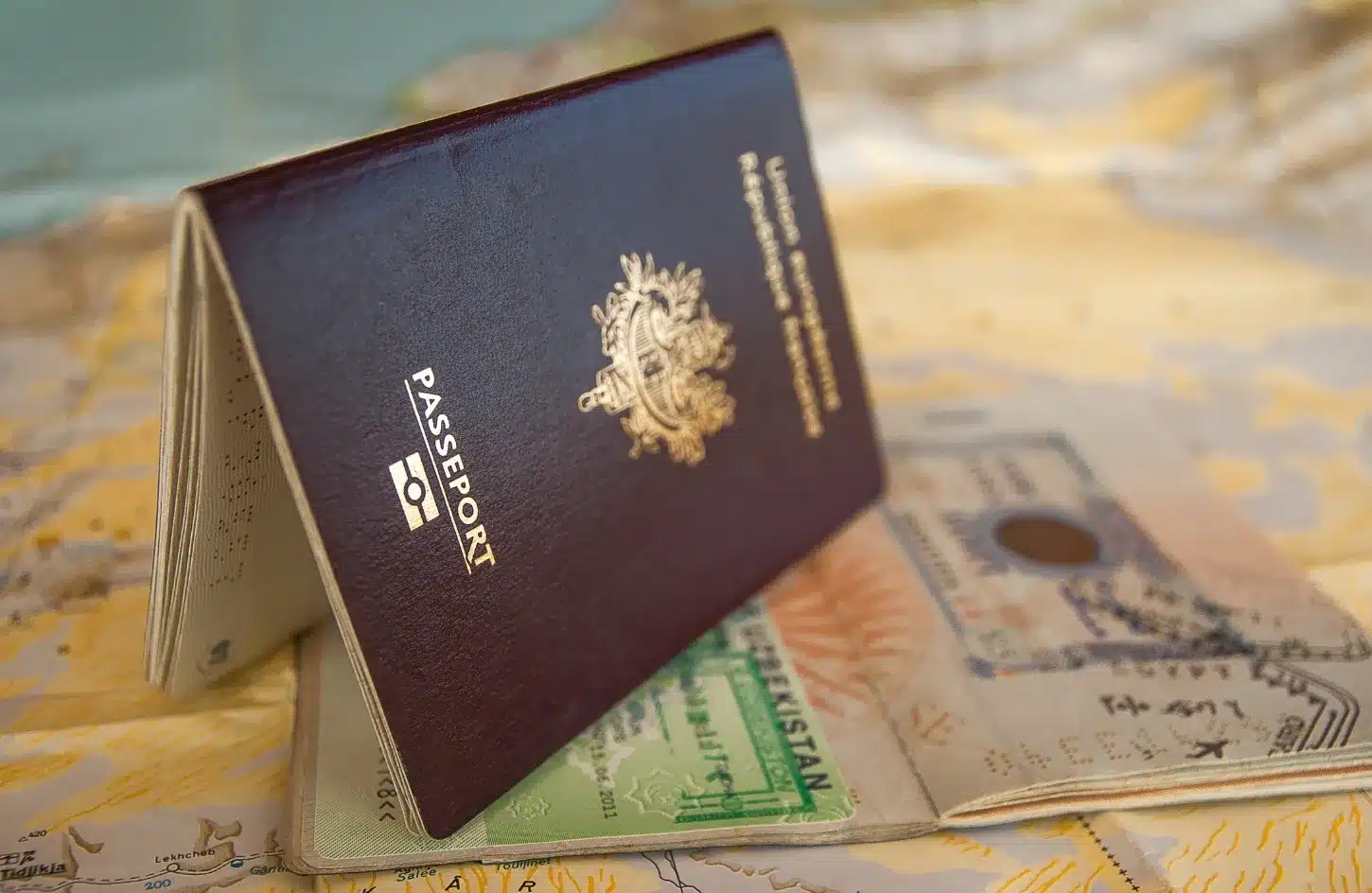 Egypt Visa Guide 2026: e-Visa, Visa on Arrival & Everything You Need to Know 2 Passport with visa and immigration stamps alongside official passport stamps used during international travel. - Egypt Visa Guide