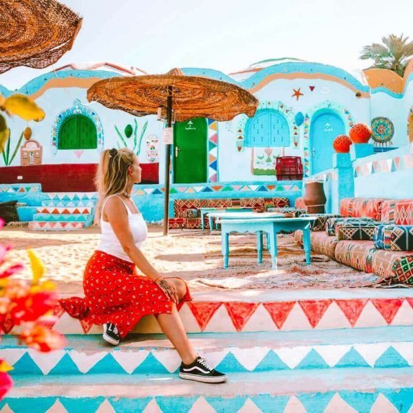 A tourist enjoys sitting in the Nubian village