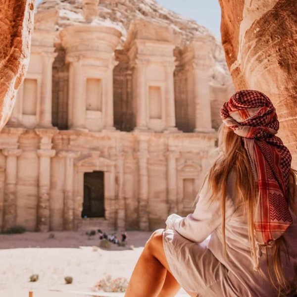 A wonderful shot of a girl from one of the caves in front of the Petra Temple in Jordan